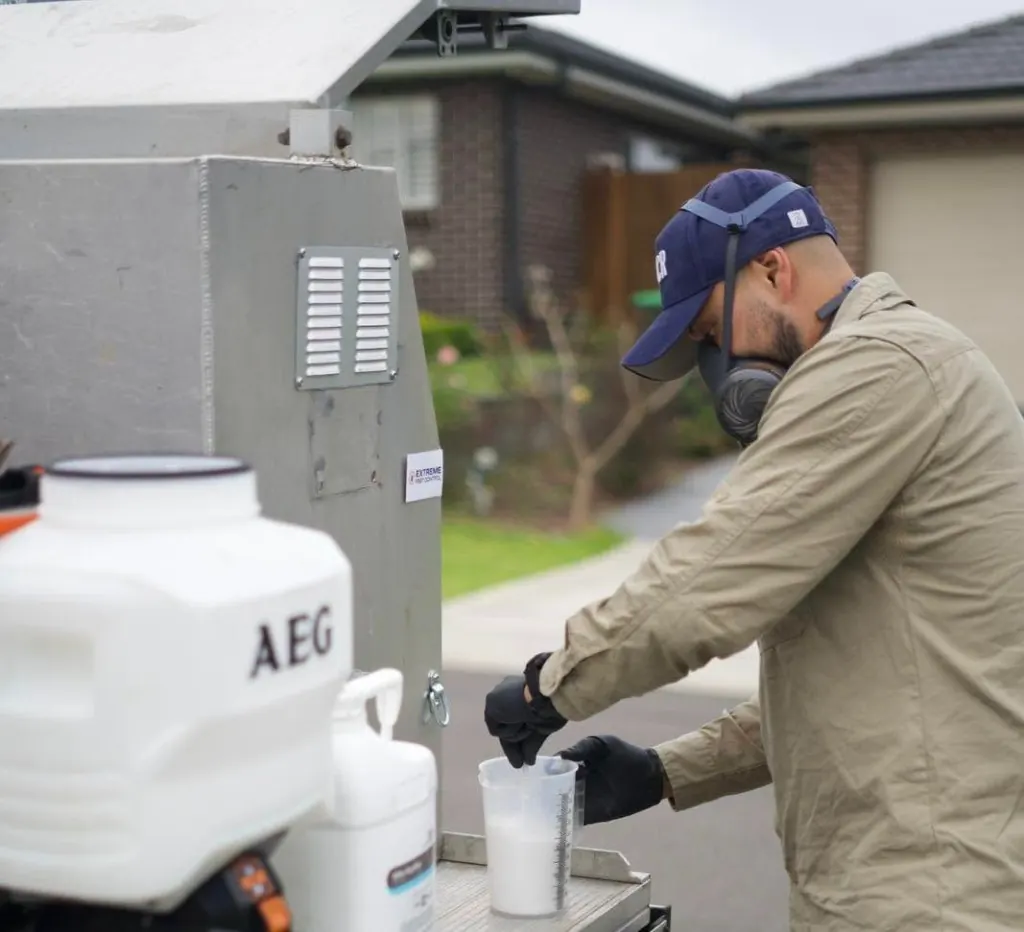 Jimmy preparing a pest treatment with protective equipment